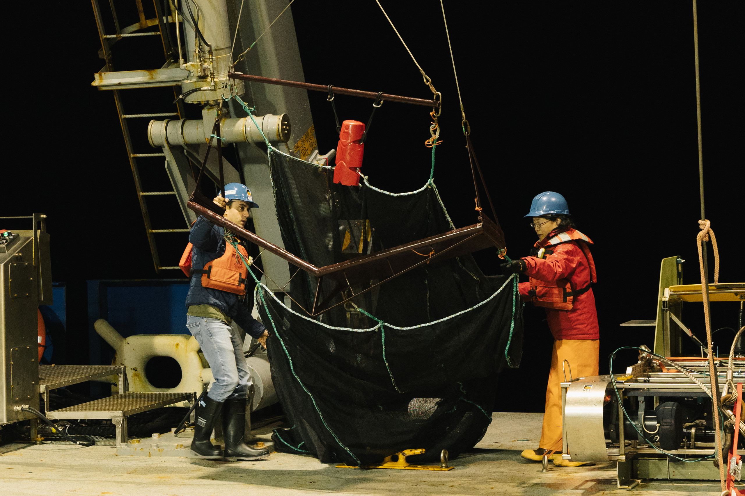 Trawl net deployment during nighttime field work.